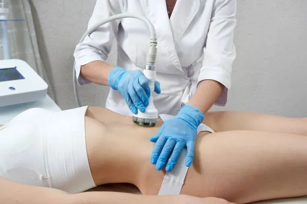 Lost the Weight but Not the Loose Skin? 2 woman having HIFU treatment on her stomach to combat loose skin Brighton and Hove following weight loss